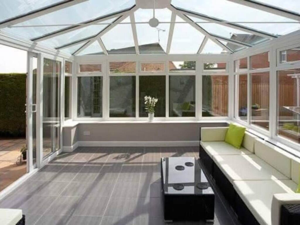 Bright conservatory interior with clean glass roof and windows allowing natural light