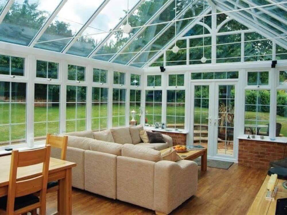 Bright glass extension interior with clean roof glazing and windows