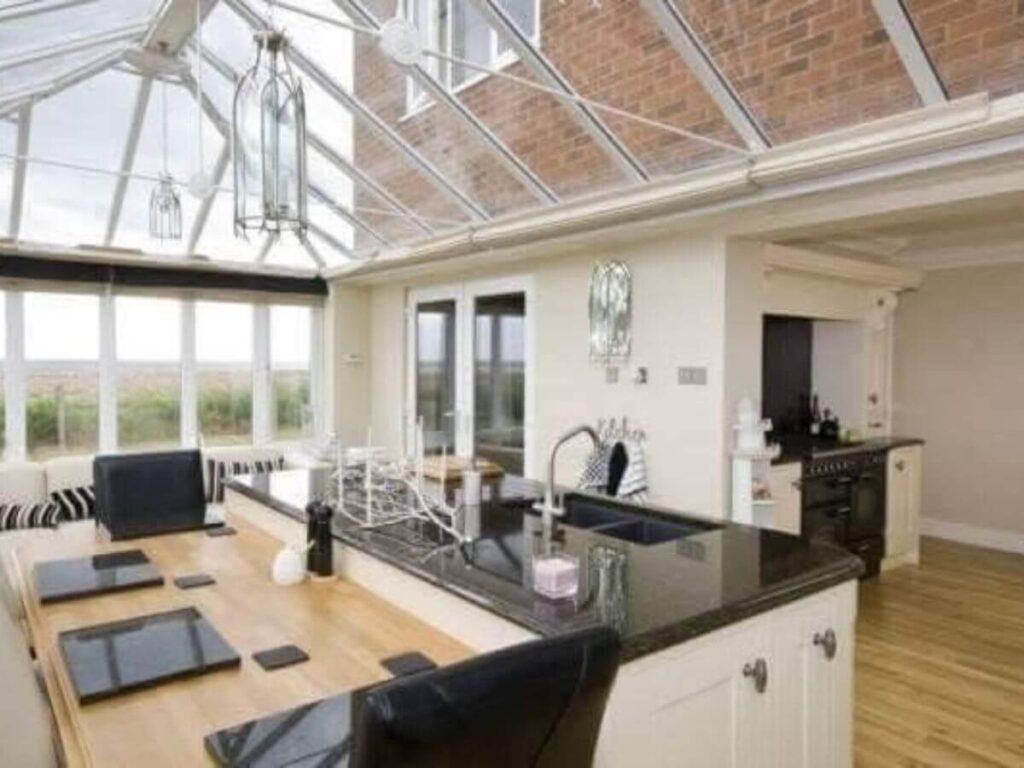 Luxury kitchen glass extension with clean roof glazing and windows