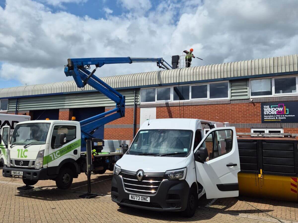 TLC Window Cleaning and Exterior Cleaning carrying out commercial roof cleaning using specialist access equipment and a cherry picker.