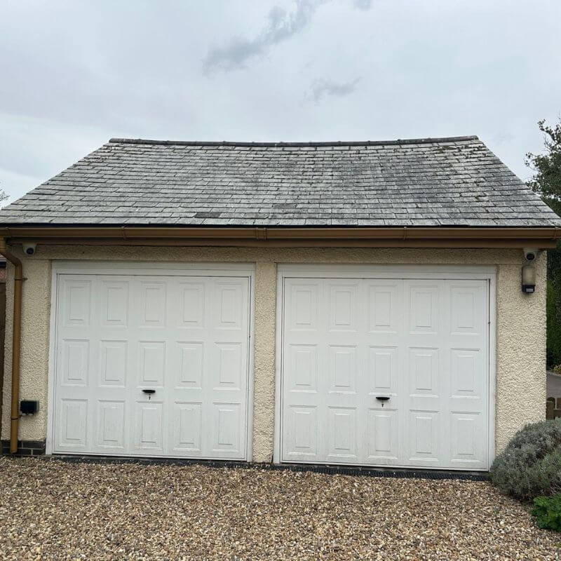 Garage roof professionally cleaned to remove moss and organic growth.