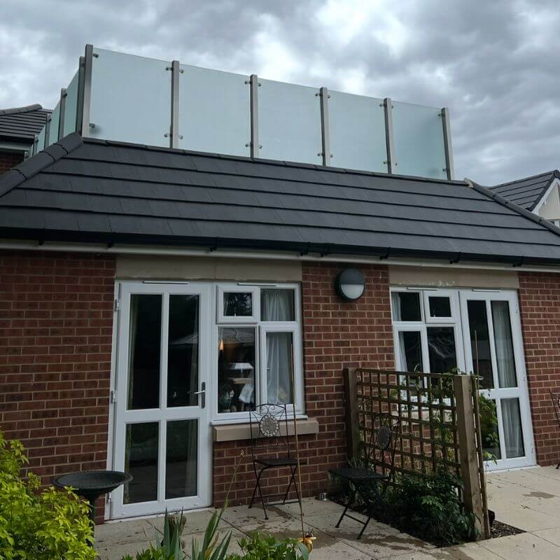 Natural slate roof cleaned to remove algae, lichen and weather staining.