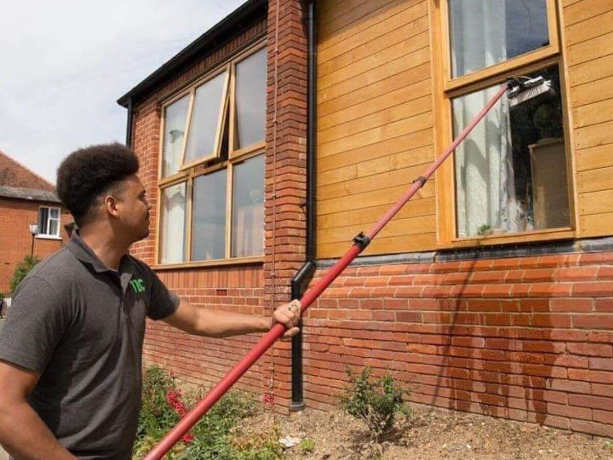 TLC Window Cleaning technician cleaning residential property windows in Suffolk
